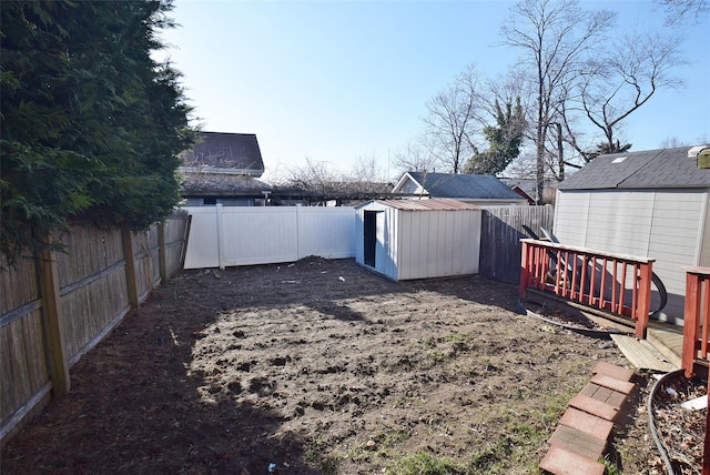 view of yard with a shed, an outdoor structure, and a fenced backyard