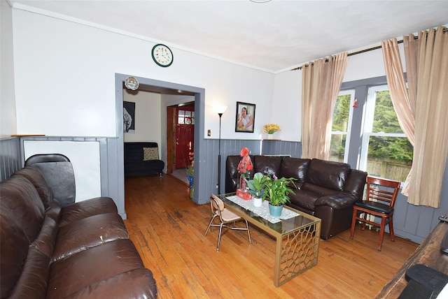 living area featuring light wood-type flooring and wainscoting