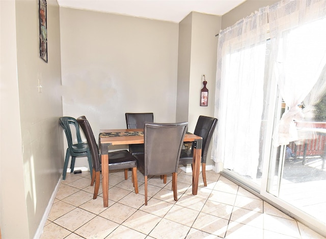 dining room with light tile patterned floors and baseboards