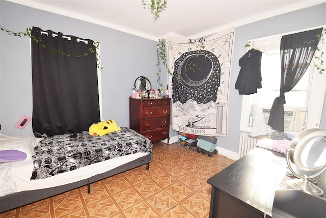 bedroom with radiator, crown molding, and baseboards