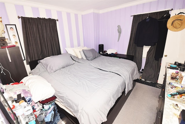 bedroom with ornamental molding and carpet flooring