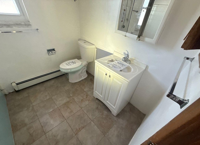 bathroom featuring a baseboard heating unit, vanity, and toilet