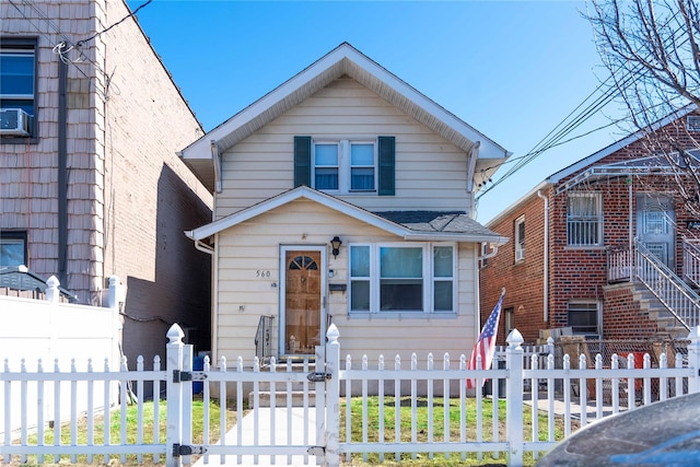 view of front of property with a fenced front yard and cooling unit