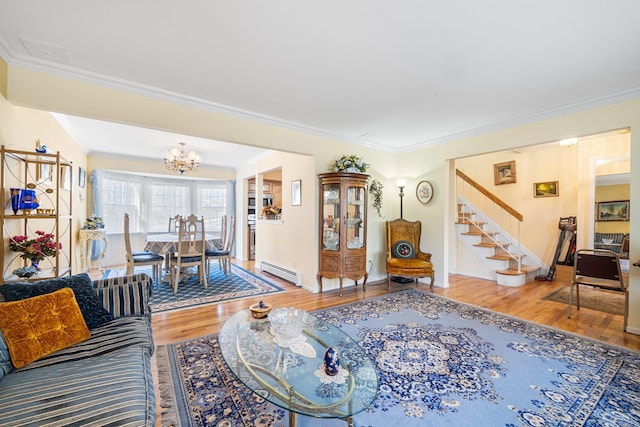 living area with a baseboard radiator, wood finished floors, stairs, an inviting chandelier, and crown molding