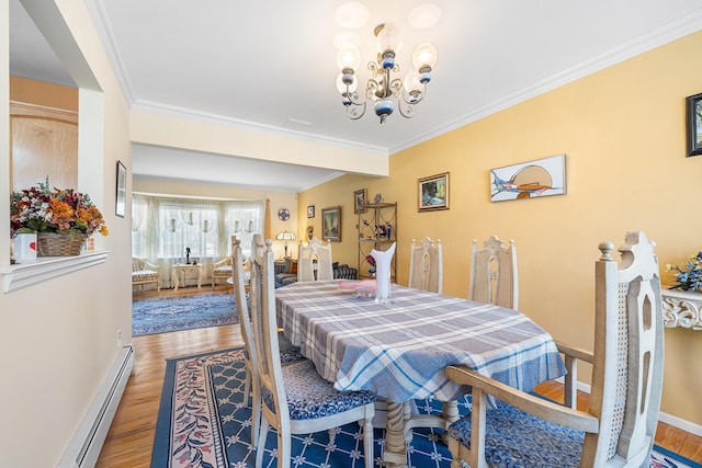 dining room with a baseboard radiator, wood finished floors, baseboards, an inviting chandelier, and crown molding