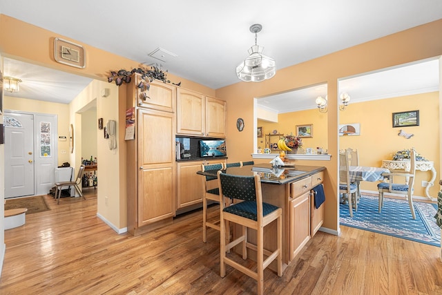 kitchen featuring dark countertops, light wood finished floors, baseboards, and light brown cabinetry