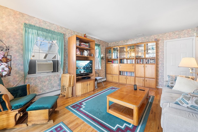 living room featuring wallpapered walls, a baseboard radiator, and wood finished floors