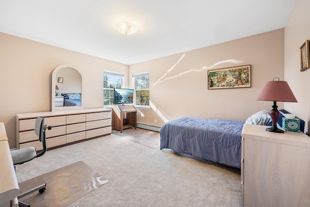 carpeted bedroom featuring a baseboard heating unit