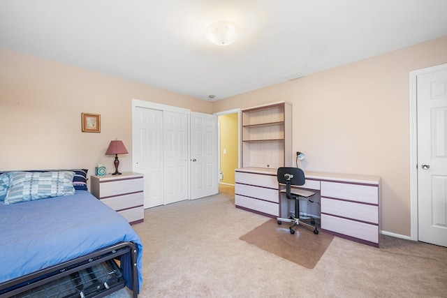 carpeted bedroom featuring a closet and baseboards