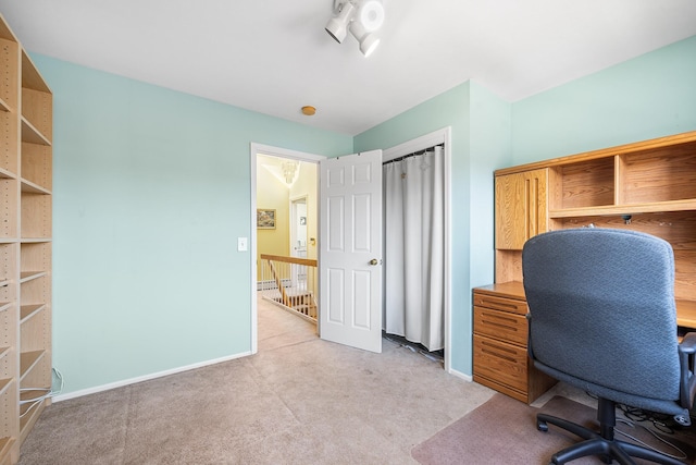 office space with light carpet and baseboards