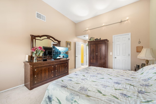 carpeted bedroom with lofted ceiling, baseboards, and visible vents