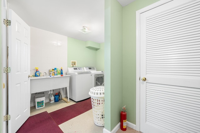 laundry room featuring laundry area, baseboards, washer and dryer, and tile patterned floors