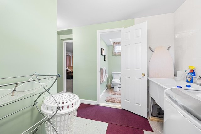 washroom featuring laundry area and baseboards