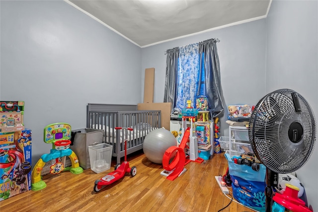 bedroom featuring hardwood / wood-style flooring and ornamental molding