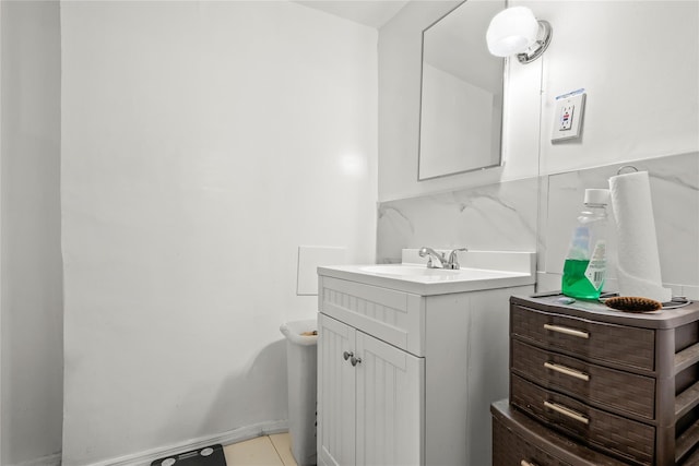 half bath with baseboards, decorative backsplash, and vanity