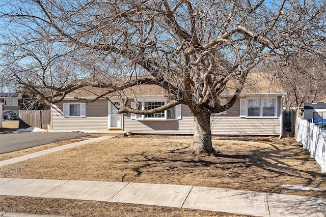 single story home with fence