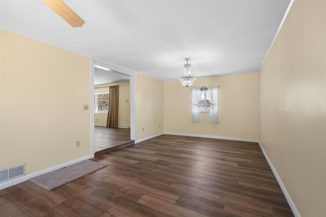 unfurnished room with a wealth of natural light, visible vents, baseboards, and wood finished floors