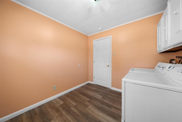 laundry area featuring baseboards, cabinet space, dark wood-type flooring, washer and dryer, and crown molding