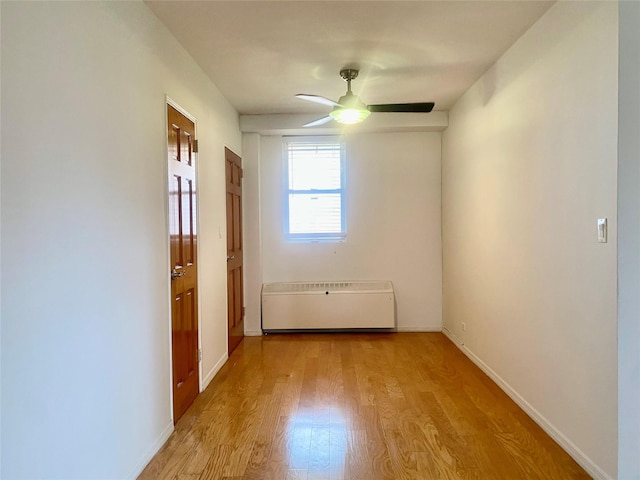 97-37 63rd Rd Unit 9H, Rego Park, NY 11374 - spare room featuring wood finished floors, ceiling fan, and radiator