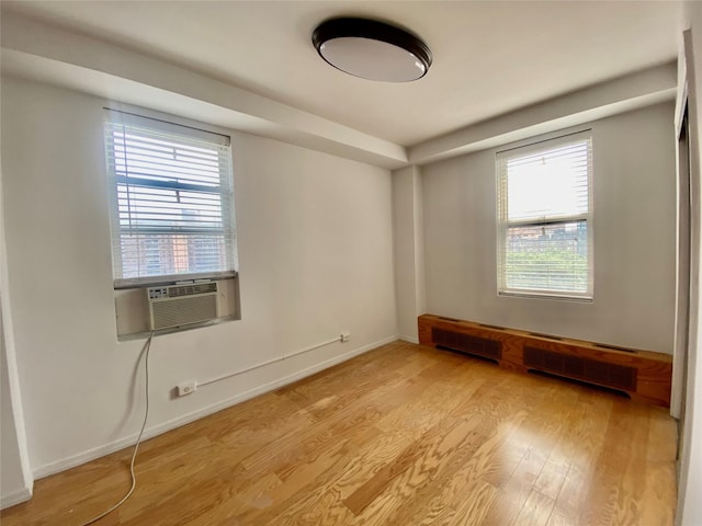 97-37 63rd Rd Unit 9H, Rego Park, NY 11374 - spare room with light wood finished floors and cooling unit