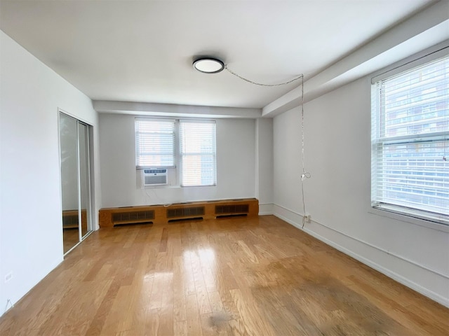 97-37 63rd Rd Unit 9H, Rego Park, NY 11374 - empty room featuring light wood-style floors and cooling unit