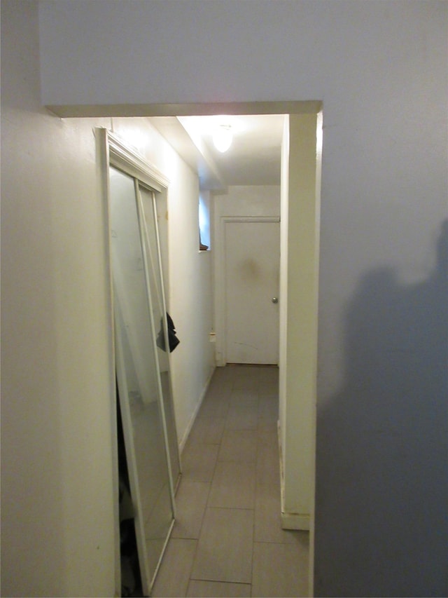 corridor featuring light tile patterned flooring