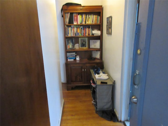 hall with wood finished floors and baseboards