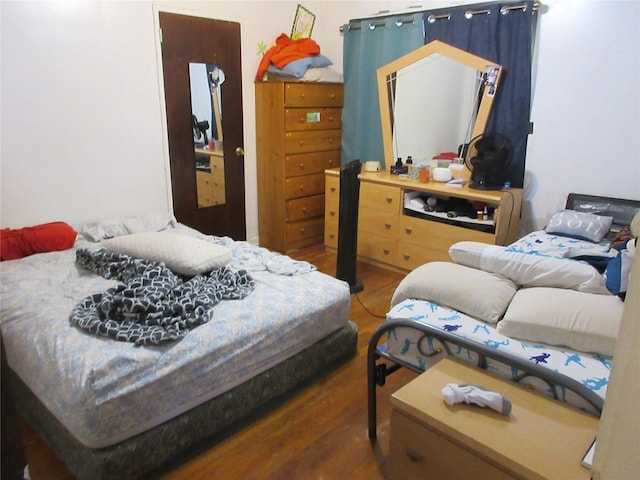 bedroom with wood finished floors