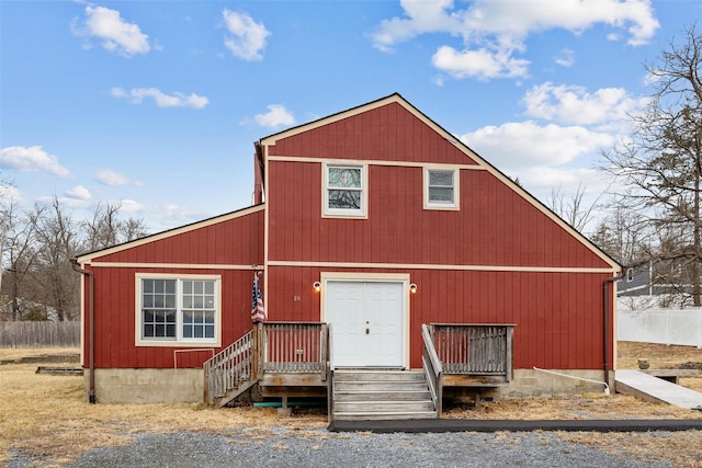 rustic home featuring a garage and an outbuilding