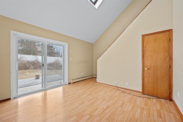 empty room featuring a baseboard heating unit, vaulted ceiling with skylight, light wood finished floors, and baseboards