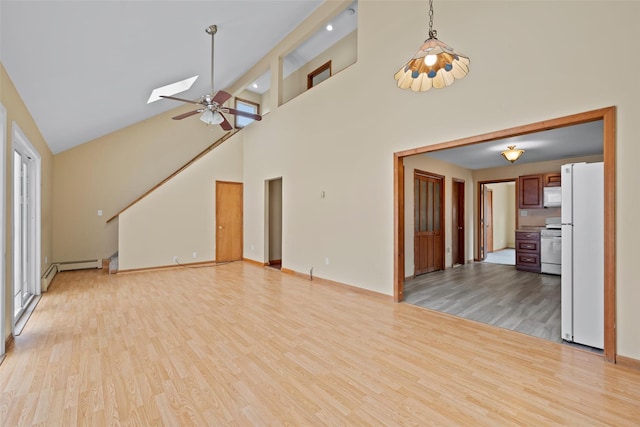 unfurnished living room with a baseboard radiator, stairway, light wood finished floors, and a skylight