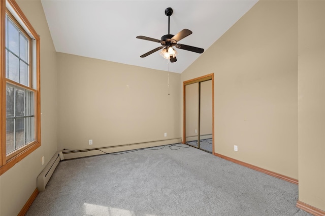 unfurnished room with lofted ceiling, carpet flooring, and baseboards