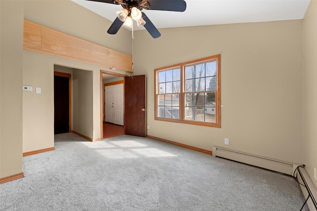 unfurnished room featuring carpet floors, a baseboard radiator, vaulted ceiling, and baseboards