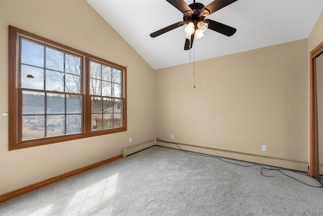 spare room featuring vaulted ceiling, ceiling fan, baseboard heating, and baseboards