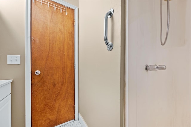 bathroom featuring a shower and vanity