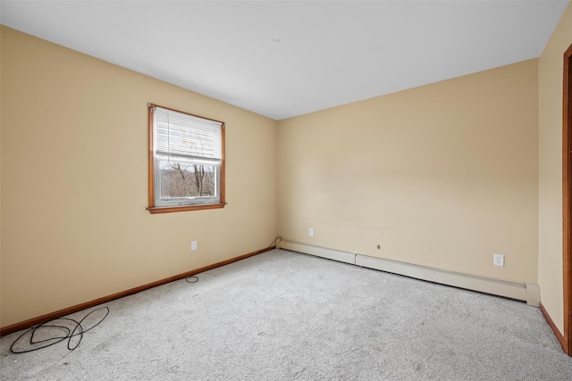 empty room with carpet floors, baseboard heating, and baseboards