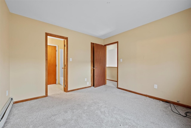 unfurnished room featuring baseboard heating, carpet flooring, and baseboards