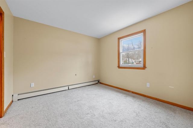 carpeted empty room with baseboard heating and baseboards