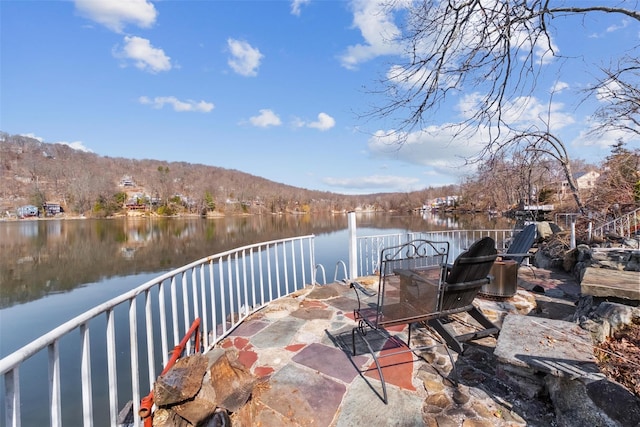 view of patio / terrace featuring a water view and outdoor dining area