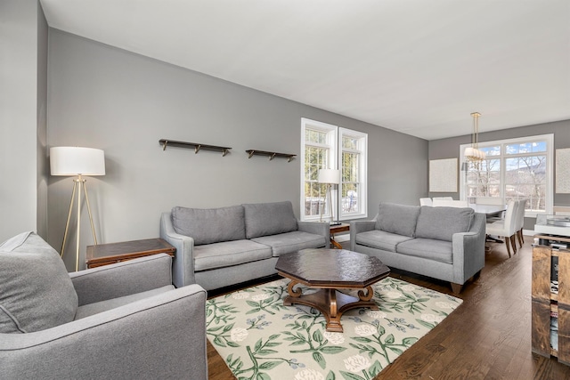 living room with a healthy amount of sunlight and dark wood-type flooring