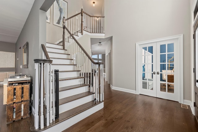 entryway featuring visible vents, baseboards, stairs, french doors, and wood finished floors