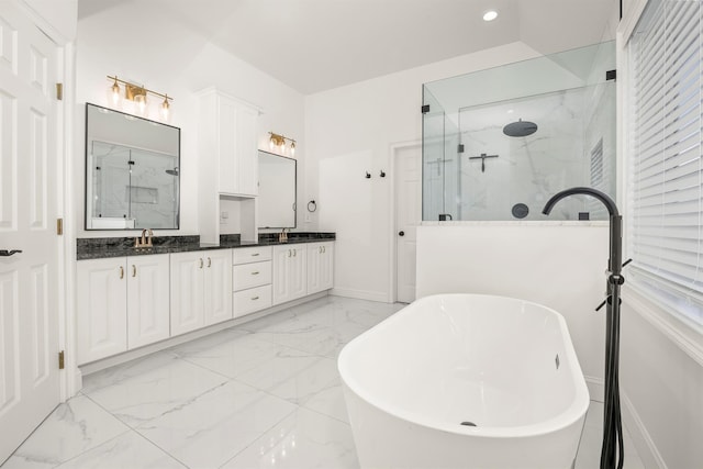 full bath featuring marble finish floor, a sink, a marble finish shower, double vanity, and a soaking tub