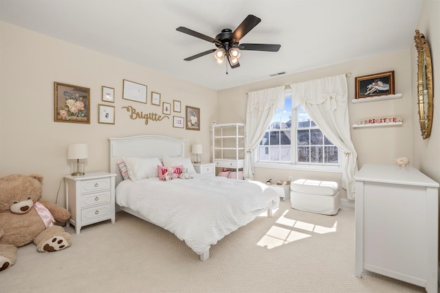 bedroom with ceiling fan, visible vents, and light carpet