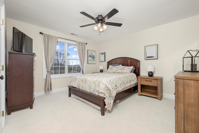 bedroom featuring a ceiling fan, baseboards, visible vents, and light carpet