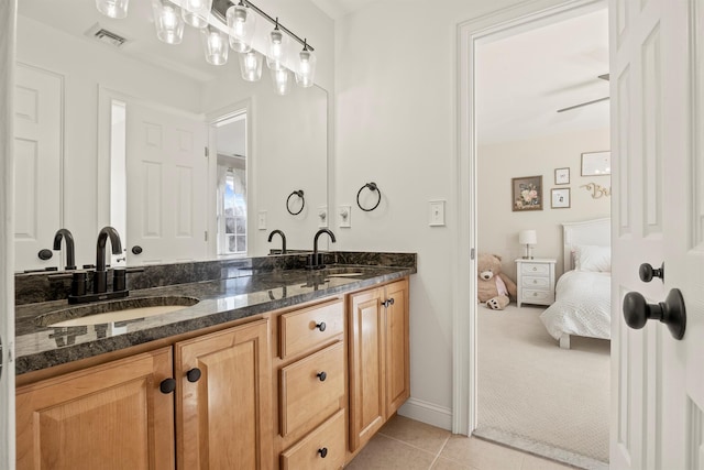 full bath featuring tile patterned flooring, visible vents, double vanity, and a sink