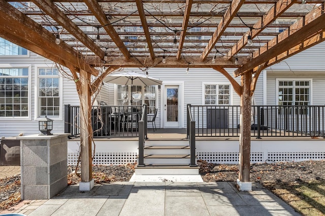 exterior space featuring a wooden deck and a pergola