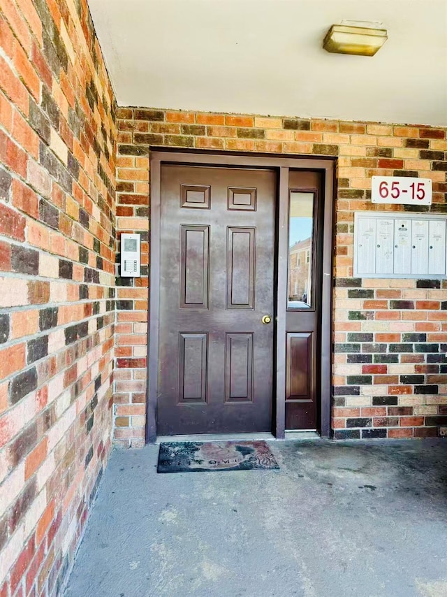 property entrance featuring brick siding