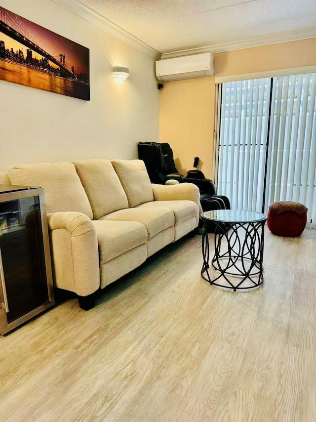 living area with a textured ceiling, ornamental molding, a wall mounted AC, and wood finished floors