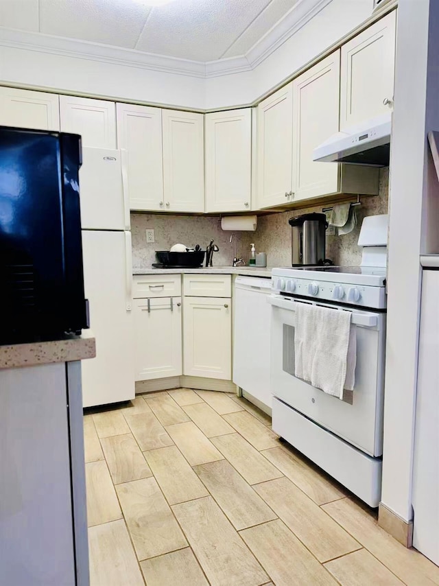 kitchen with ornamental molding, white appliances, under cabinet range hood, and decorative backsplash