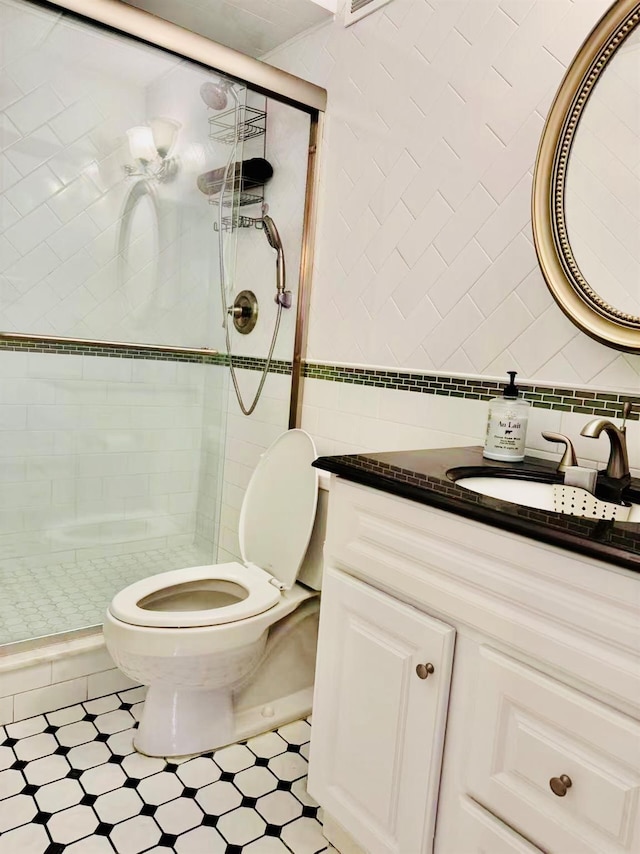 full bath featuring toilet, a shower stall, tile walls, and vanity